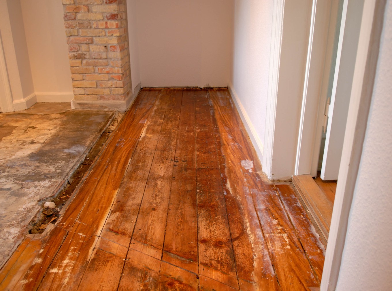 Very damaged hardwood floor in the middle of a home renovation.